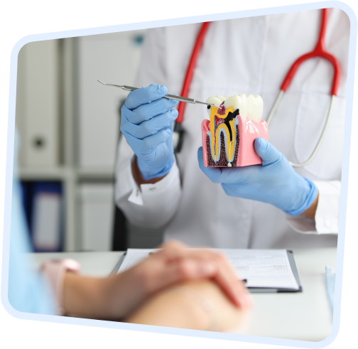 a close up of a person in a white coat and blue gloves holding a toothbrush