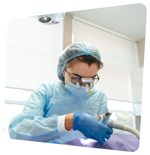 arafed woman in a blue gown and blue gloves is using a blow dryer