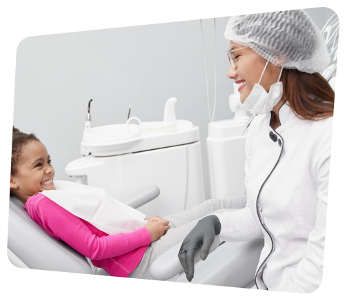 a woman in a dentist chair with a little girl sitting in the chair