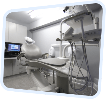 a close up of a medical room with a television and a chair