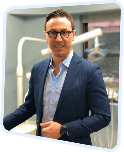 arafed man in a suit and glasses standing in a dental room