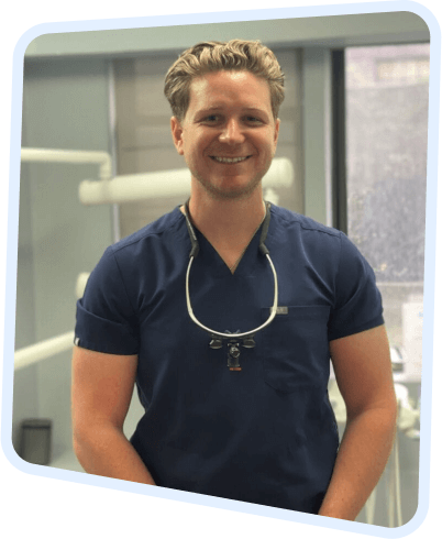 a close up of a man in a blue shirt with a stethoscope