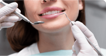 woman getting her teeth brushed by a dentist in a dental office