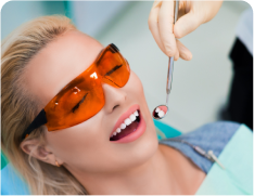 blond woman with sunglasses and a toothbrush in a dental office