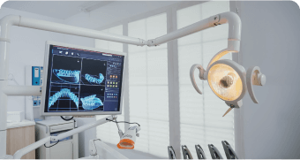 there is a computer screen that is on a dental chair