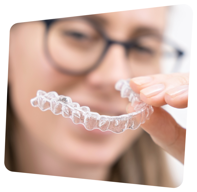 a close up of a woman holding a clear plastic retainer