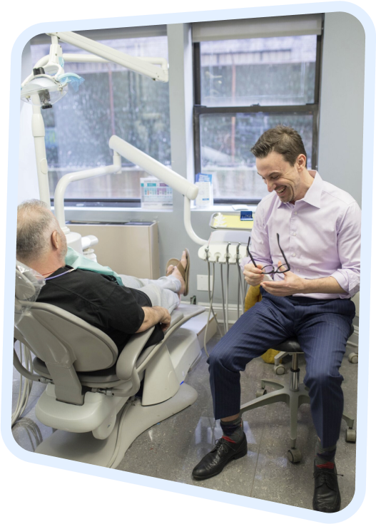 arafed man sitting in a chair with a patient in a dental room