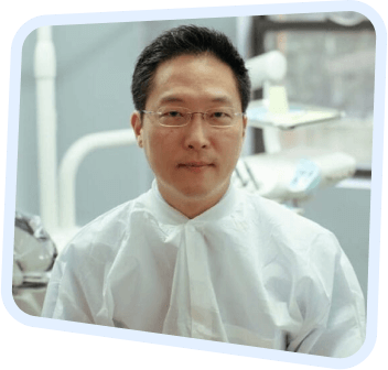 arafed man in a white shirt and glasses in a dental room