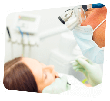 arafed woman in a dental gown and mask getting her teeth examined