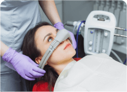 arafed woman with a mask on her face in a dentist ' s chair