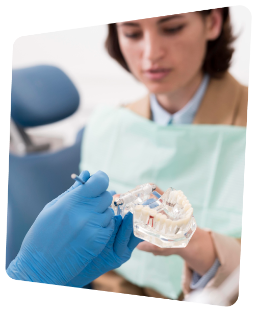 a woman in a dental gown holding a toothbrush and a dental device