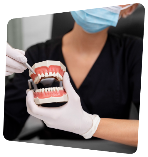 a close up of a person in a black shirt and white gloves holding a fake teeth