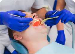 arafed man getting his teeth examined by a dentist