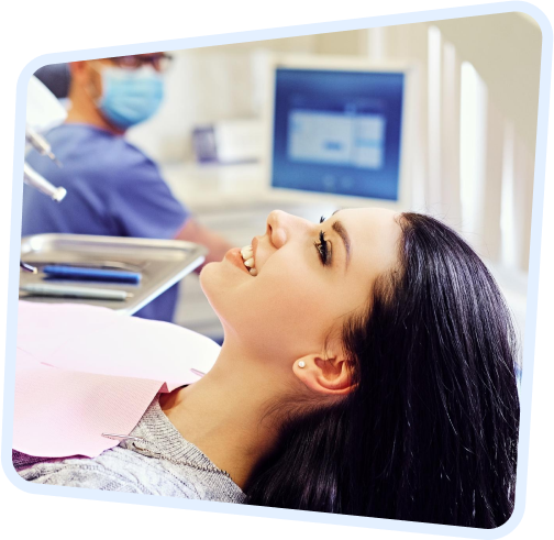 arafed woman in a dental chair with a dentist in the background