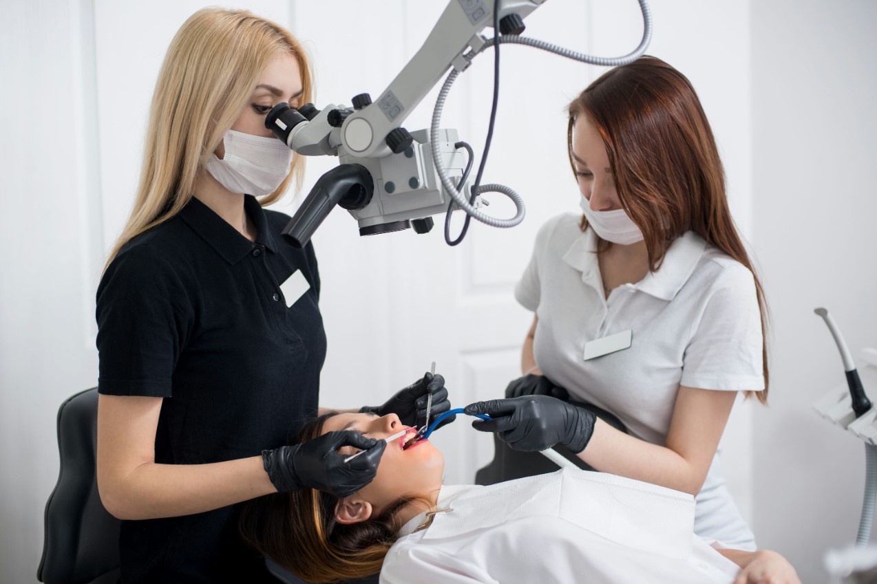 woman getting a dental check up at a dentist ' s office