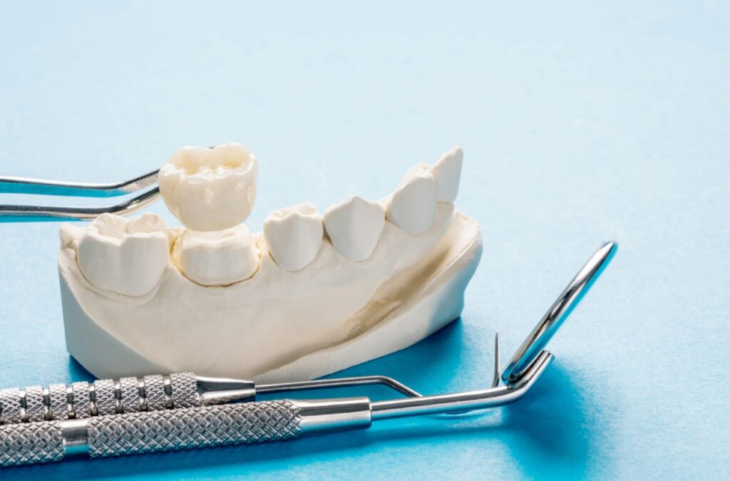 a close up of a dental device and a toothbrush on a blue surface