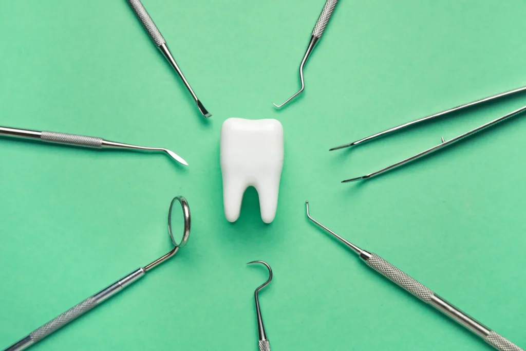 a close up of a tooth and dental tools arranged in a circle