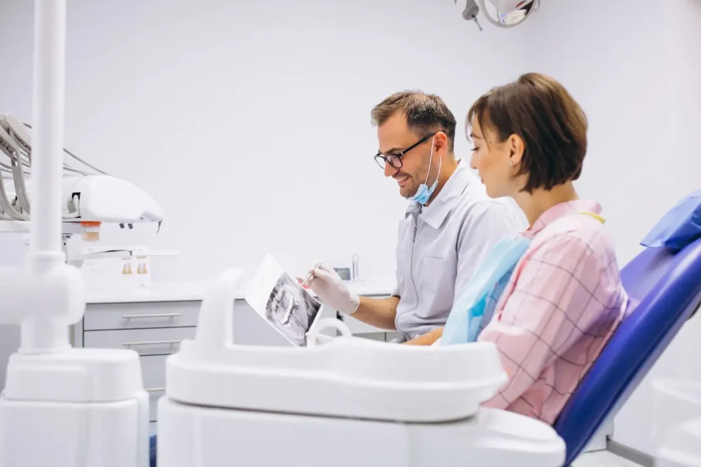 arafed man and woman sitting in a dental chair